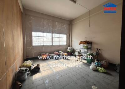 Spacious room in need of renovation with cluttered floor and natural light