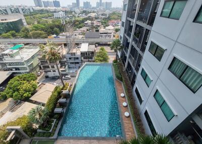 Outdoor swimming pool between modern residential buildings