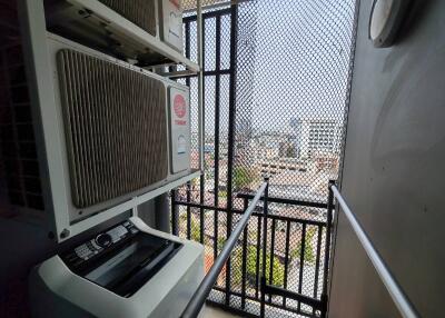 Balcony view with air conditioning units and cityscape