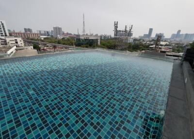 Elevated outdoor swimming pool overlooking cityscape