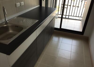 Modern kitchen with stainless steel sink and balcony access
