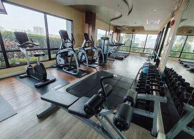 Well-equipped indoor gym with various exercise machines and weights