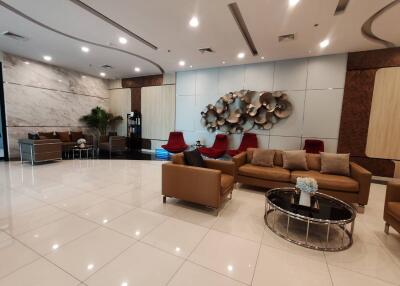 Spacious and modern lobby with stylish seating and decorative art pieces
