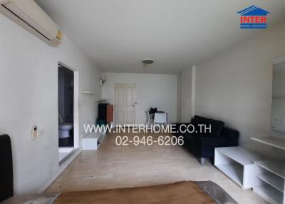 living room with partial furnishings and visible air conditioner