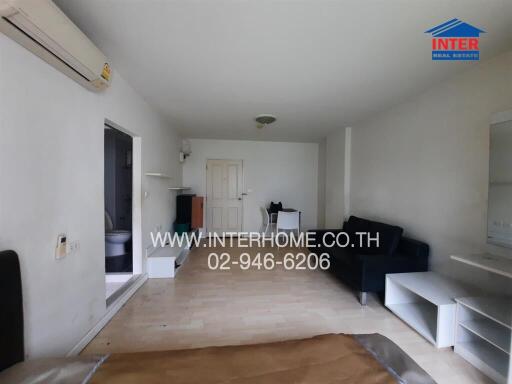 living room with partial furnishings and visible air conditioner