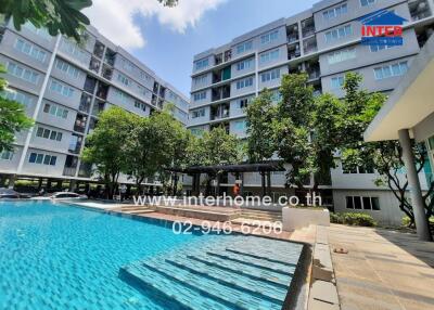 Modern apartment building with outdoor swimming pool and landscaped area