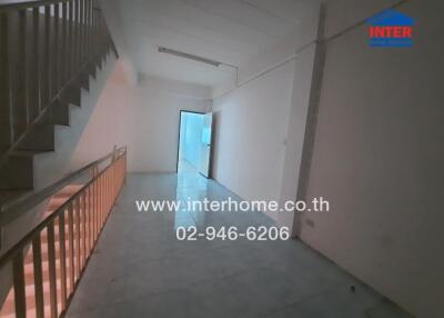 Interior view of a spacious hallway with stair access in a building