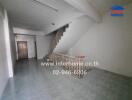 Spacious living room with staircase and tiled flooring