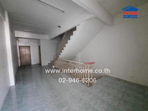 Spacious living room with staircase and tiled flooring