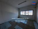 Empty room with tile floor and large window in an apartment