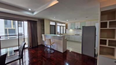 Spacious open floor plan living room with adjacent modern kitchen