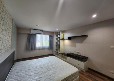 Spacious bedroom with modern decor and ample lighting