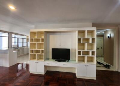 Spacious living room with large white entertainment unit and hardwood flooring