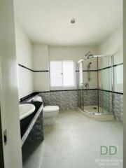 Modern bathroom with shower cubicle and dual sinks