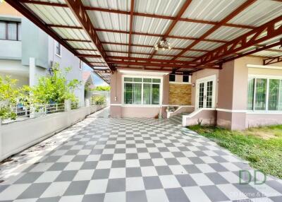 Spacious covered patio area with checkered floor and comfortable seating