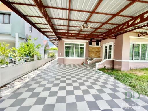 Spacious covered patio area with checkered floor and comfortable seating