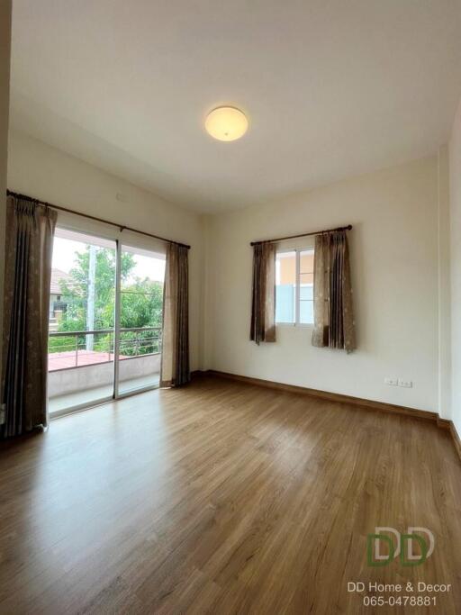 Spacious bedroom with large windows and balcony access