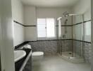 Spacious modern bathroom with dual sinks and glass shower enclosure