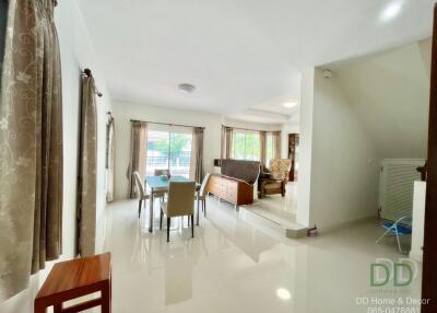 Spacious and well-lit living room with dining area