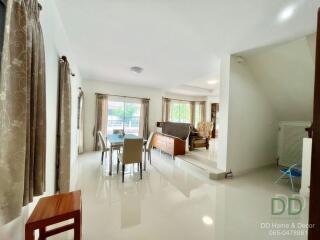 Spacious and well-lit living room with dining area