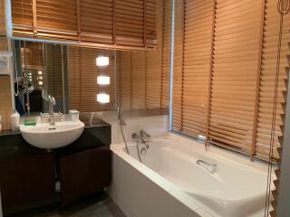 Modern bathroom with wooden blinds and well-lit vanity area