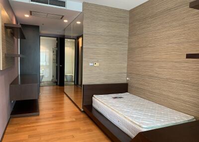 Modern bedroom with elegant wall design and wooden floors