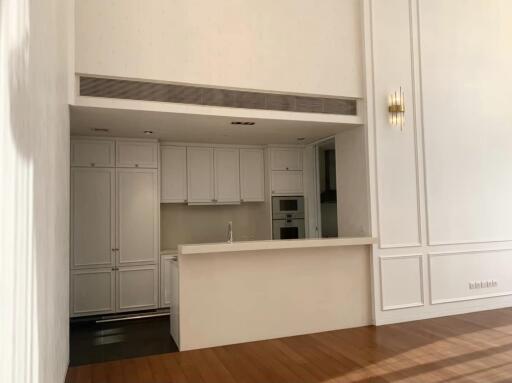 Modern kitchen with white cabinetry and wooden floors