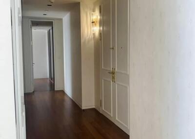 Spacious hallway with hardwood floors and built-in storage