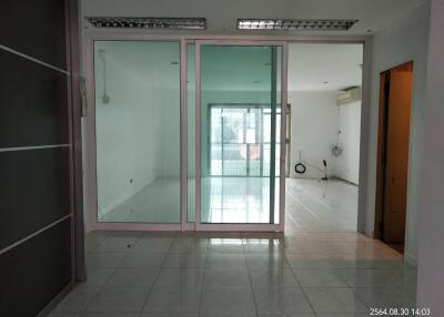 Spacious living area with large glass doors leading to a balcony