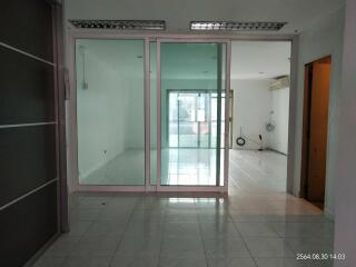 Spacious living area with large glass doors leading to a balcony