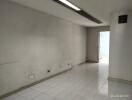 Spacious and bright empty room with tiled flooring