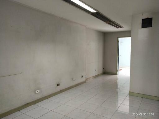 Spacious and bright empty room with tiled flooring