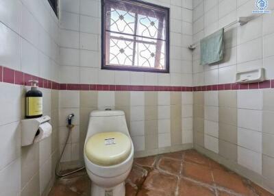 Clean bathroom with natural light and terracotta tiles