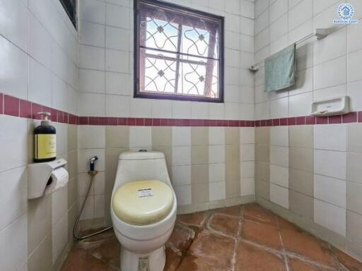 Clean bathroom with natural light and terracotta tiles