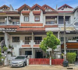 Exterior view of a townhouse with parked car