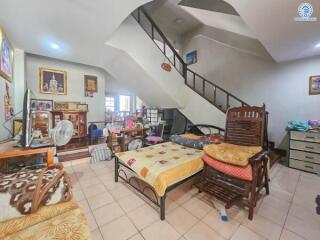 Spacious multi-functional bedroom with staircase and wooden furniture