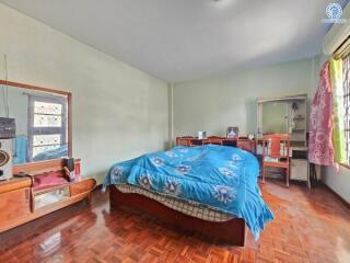 Spacious bedroom with large windows and ample natural light