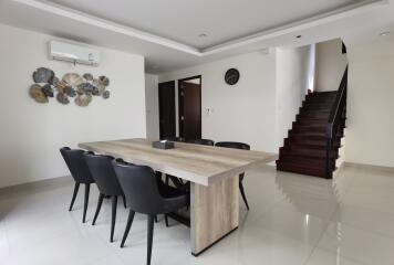 Modern dining room with staircase and elegant decor