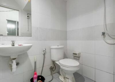 Clean white tiled bathroom with modern fixtures