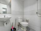 Clean white tiled bathroom with modern fixtures