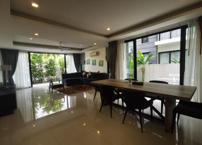 Spacious and modern living room with dining area and large windows