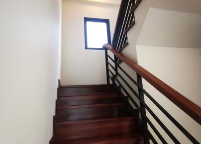 Elegant wooden staircase with sleek metal railings in a modern home