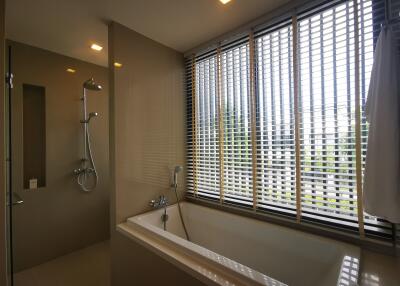 Modern bathroom with large bathtub and natural light