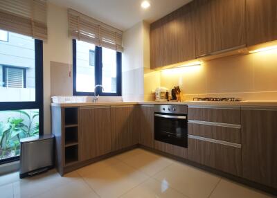 Modern kitchen with wood cabinets and built-in appliances