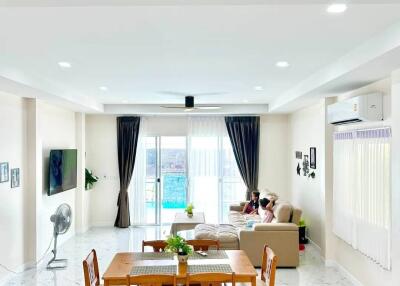 Spacious and well-lit living room with dining area