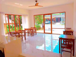 Bright and spacious dining room with large windows and marble flooring