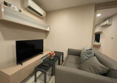 Modern living room interior with comfortable sofa and wall-mounted TV