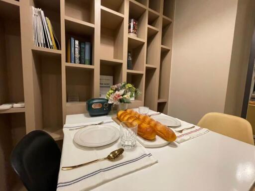 Cozy dining area with modern shelving, elegant table setting, and retro radio