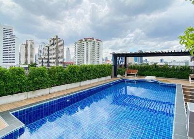 Luxury rooftop swimming pool with city skyline view