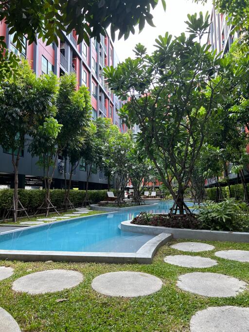 Lush garden and swimming pool in a modern residential apartment complex